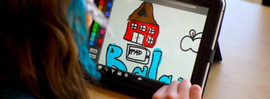 Foto de uma criança desenhando um tablete.