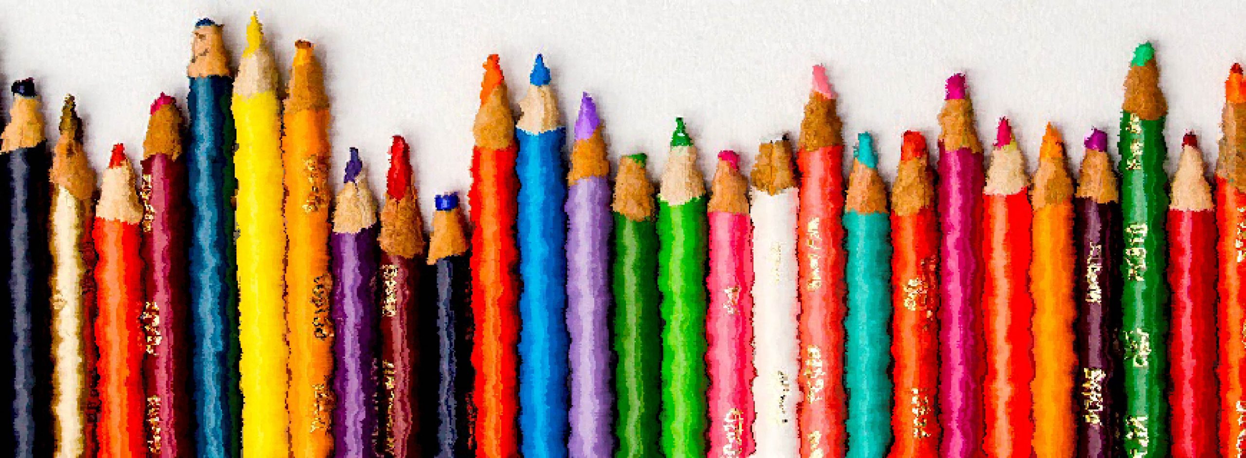 Foto com vários lápis de cor um ao lado do outro.