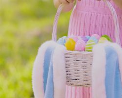 Imagem de uma criança segurando uma cesta com ovos de páscoa. A foto ilustra a matéria "Instituto Alana denuncia Cacau Show por publicidade infantil".